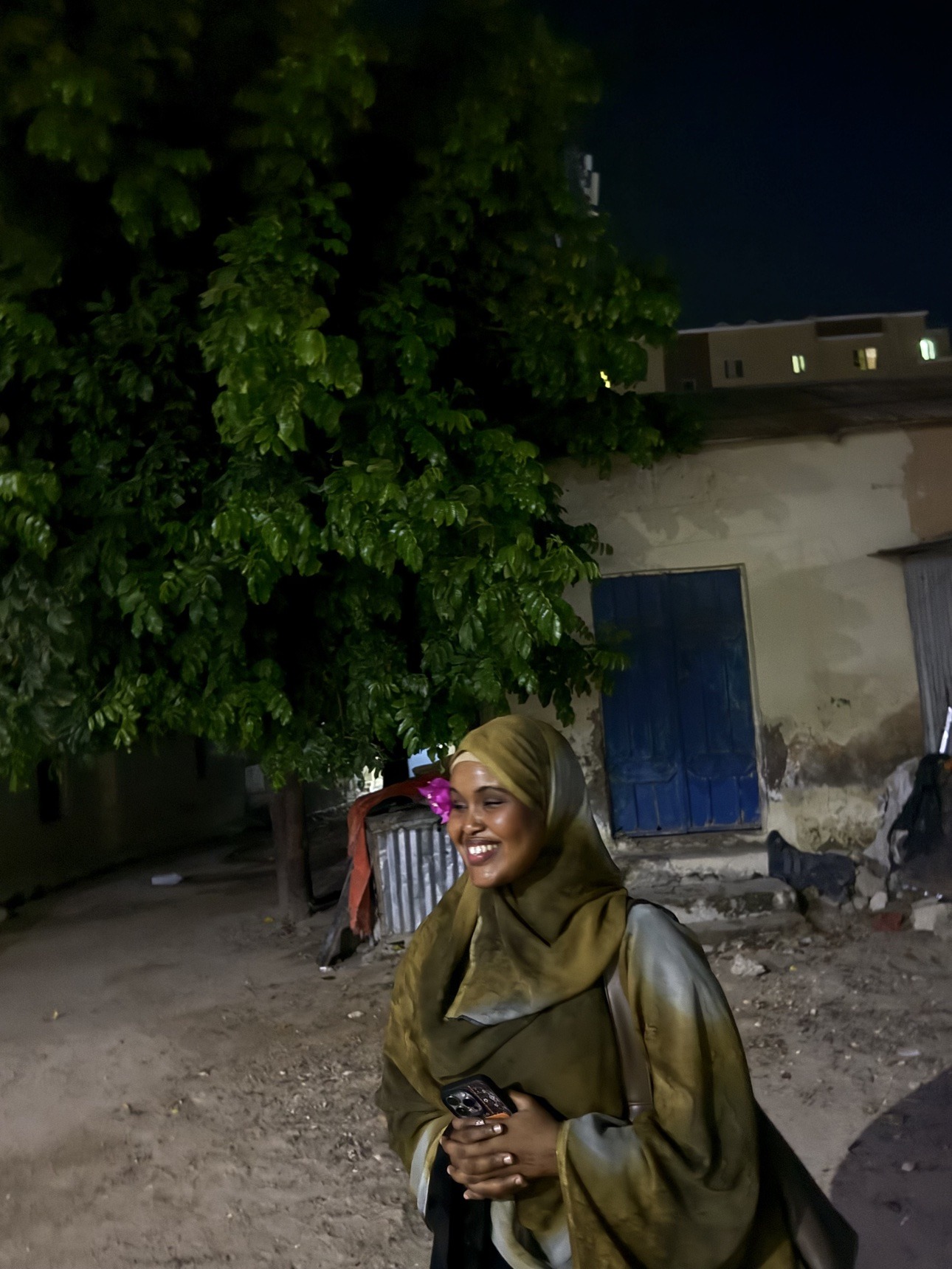 Her smiling outside at night