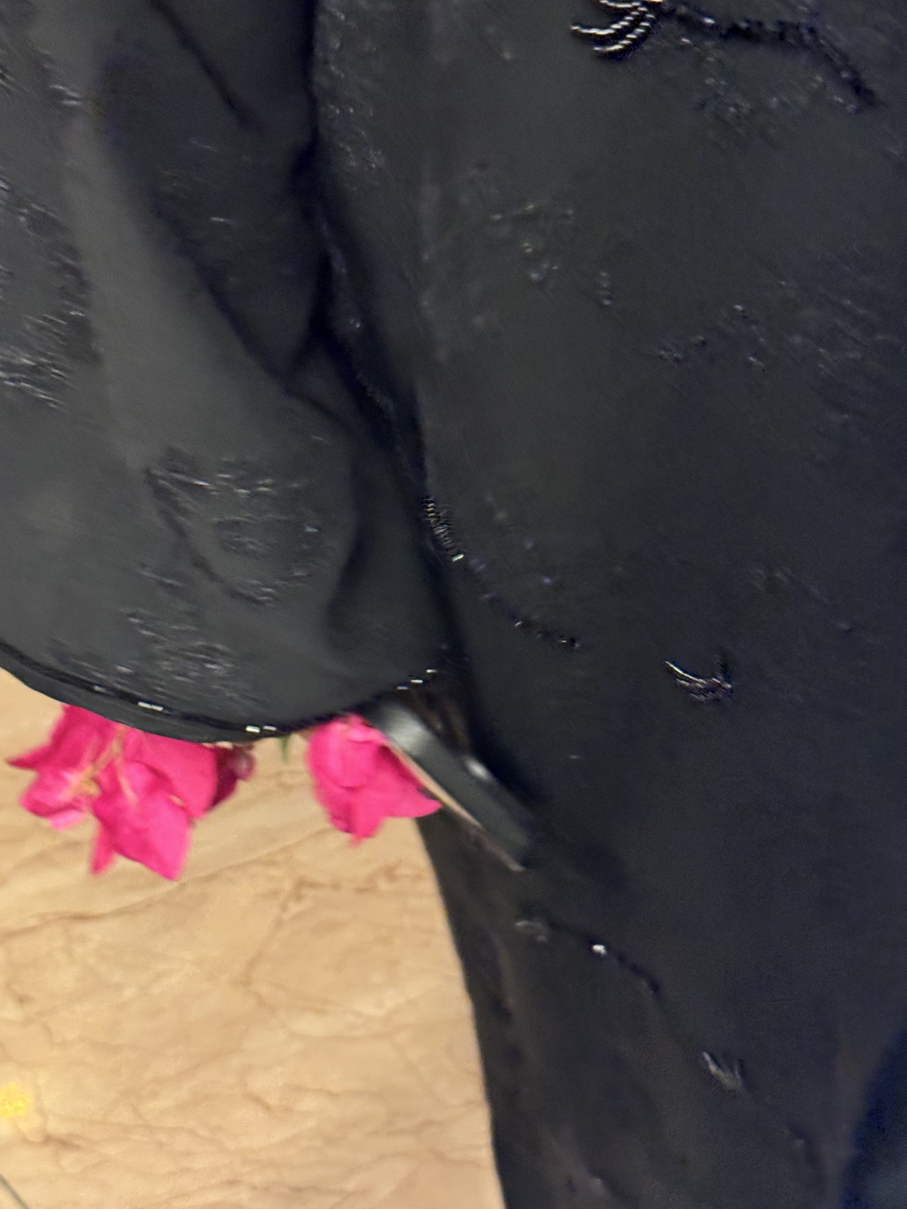 Black abaya detail with pink flowers